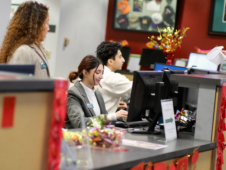 International students working at the front desk in the International Programs office