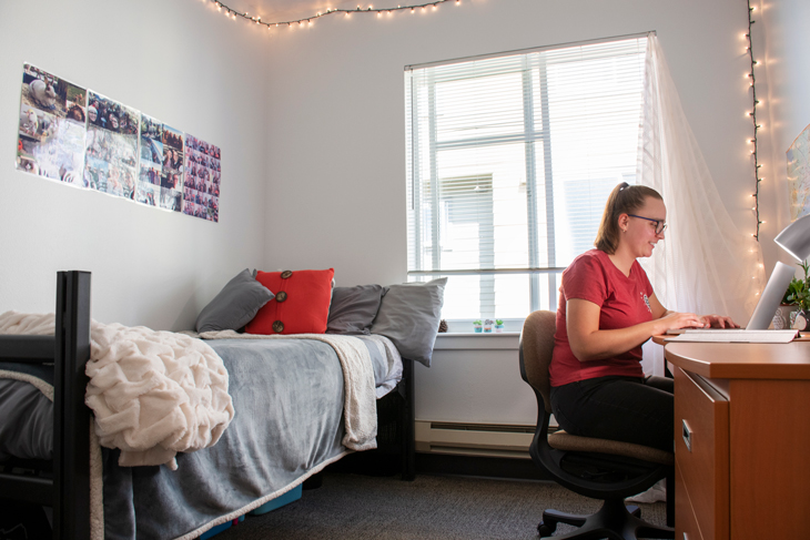 Naomi van Roon studies in her newly renovated Campus Corner Apartment bedroom. 