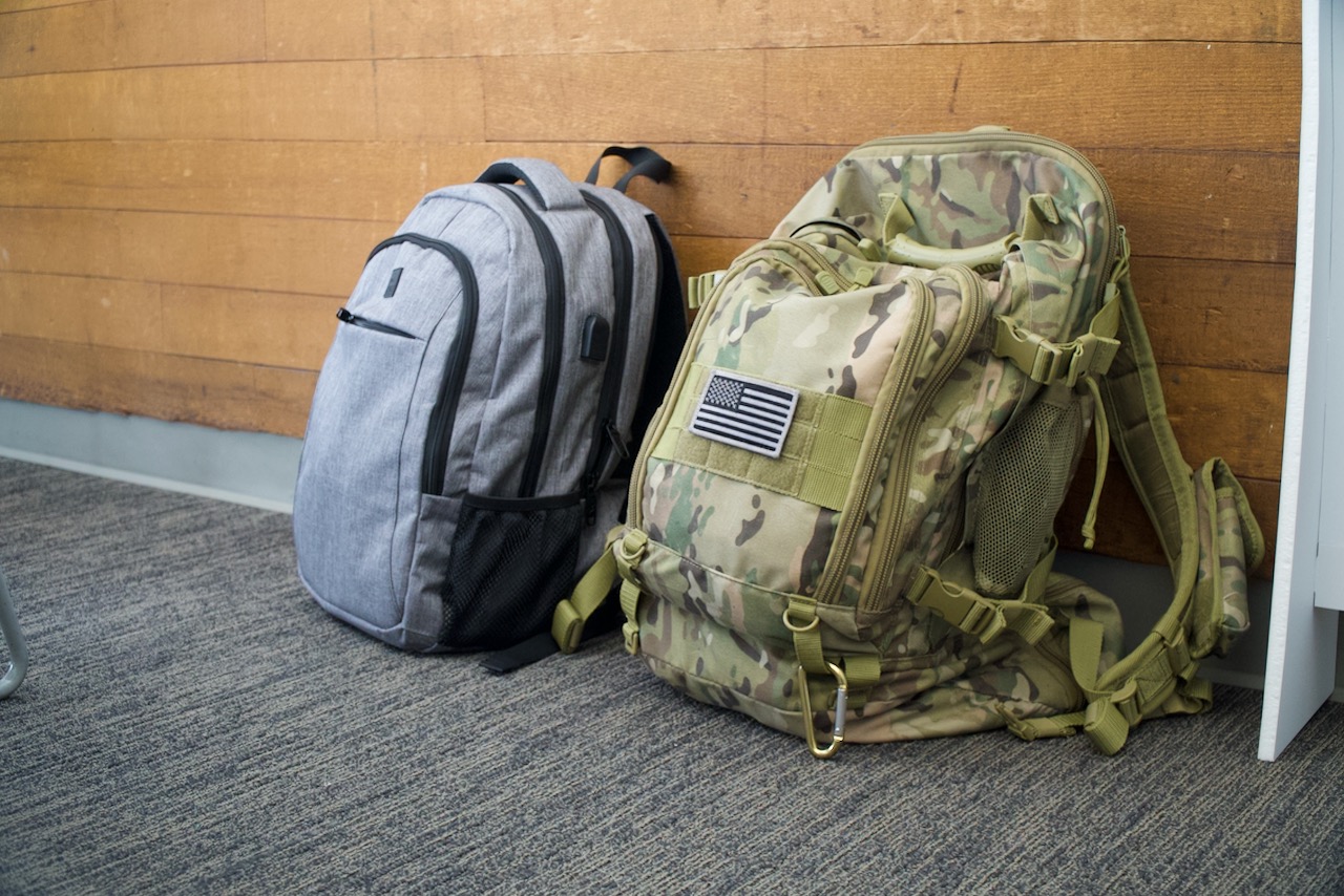 Camo backpack leaning against wall in GRC Veterans Lounge