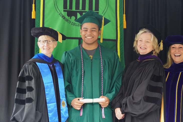 Graduate posed with Dr. Johnson and Board Chair Parini