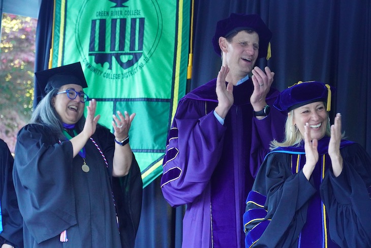 Faculty, staff, administrators and board trustees cheer on graduates
