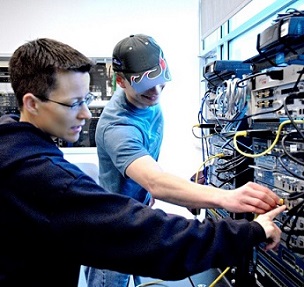 Instructor working with Student on computer hardware
