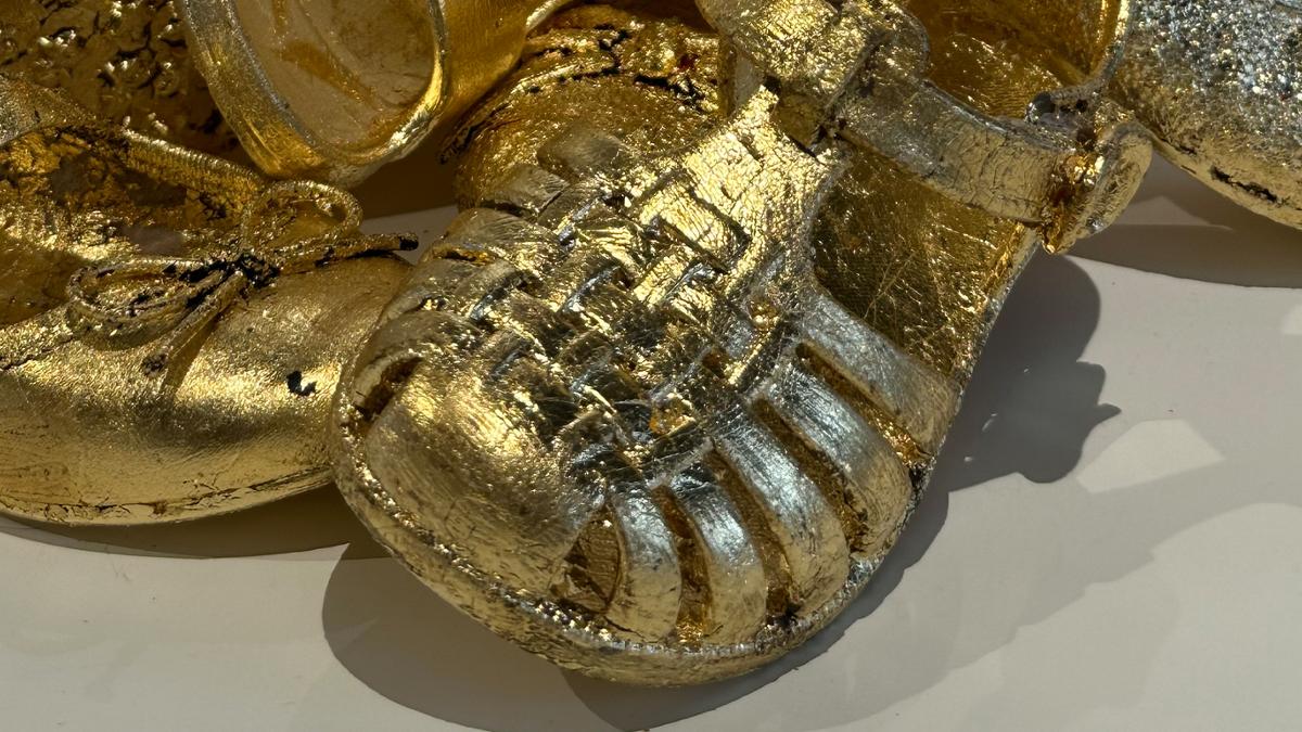 Shoes covered in gold-leafing.