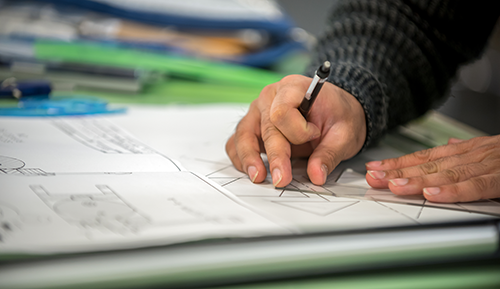 A person working with a technical drawing